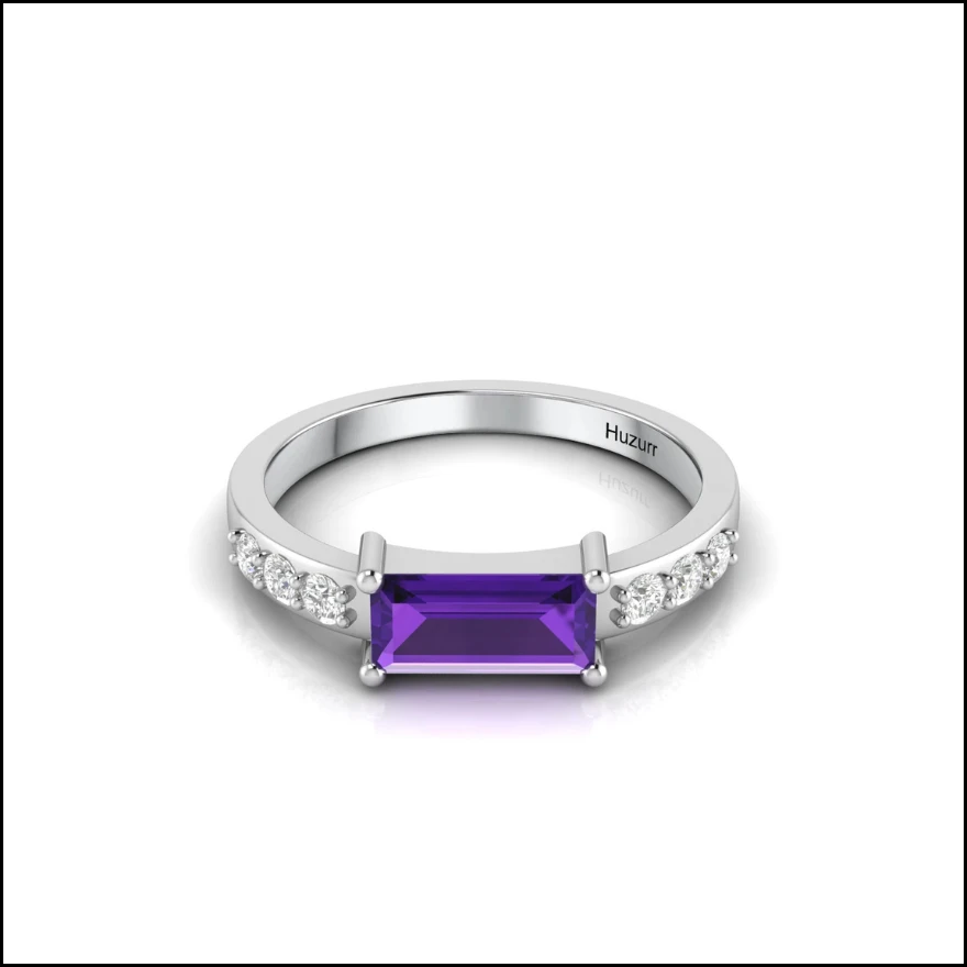 East-west baguette cut purple amethyst gemstone solitaire ring with small diamond stones on a sterling silver band
