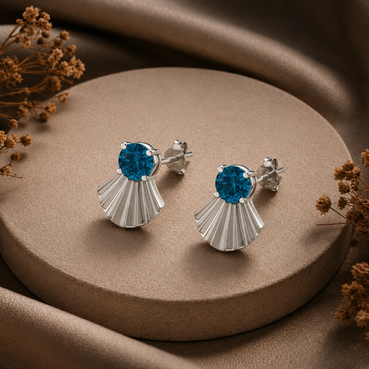 fantail shaped silver stud tops accented with rich blue colored diamonds