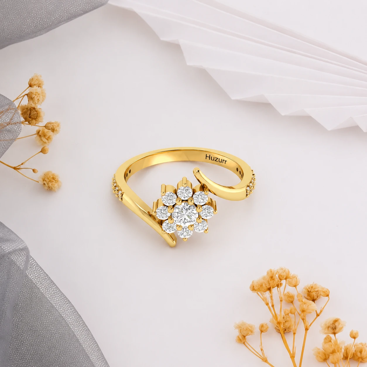 Gold plated bypass ring featuring a central cluster flower design made entirely of round diamonds