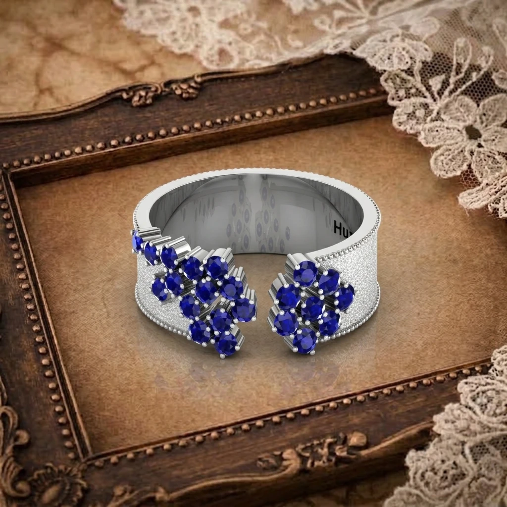 Open cuff bypass band ring featuring flower clustered round blue sapphires on silver band
