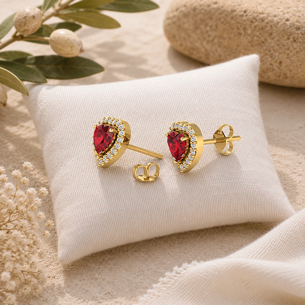 Heart shaped red garnet gold plated stud earrings surrounded by a halo of tiny shimmering diamonds.