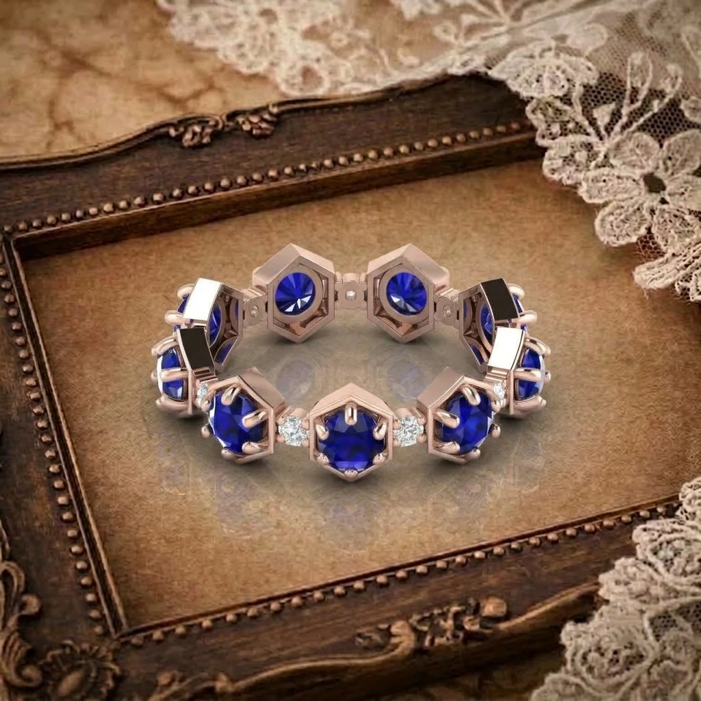 Hexagonal bezel set round blue sapphire and diamond eternity band ring in rose gold plated metal