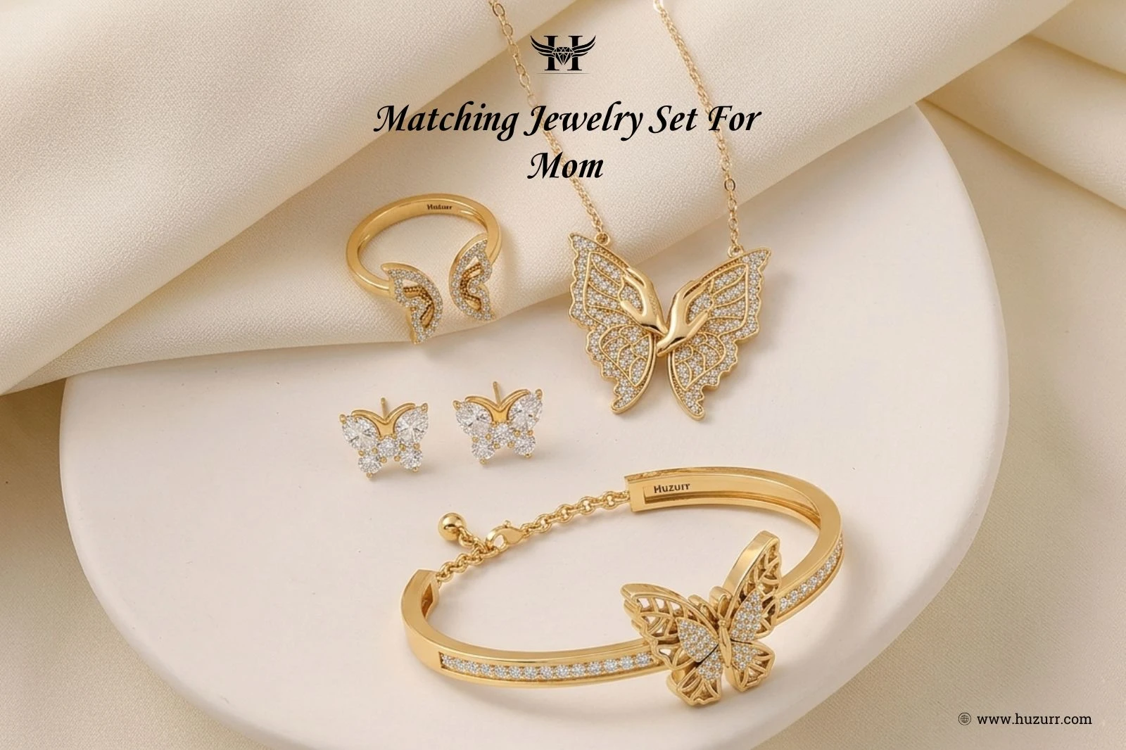 Coordinated jewelry set featuring a gold plated butterfly pendant necklace, stud earrings, open ring, and adjustable bangle with diamond accents.