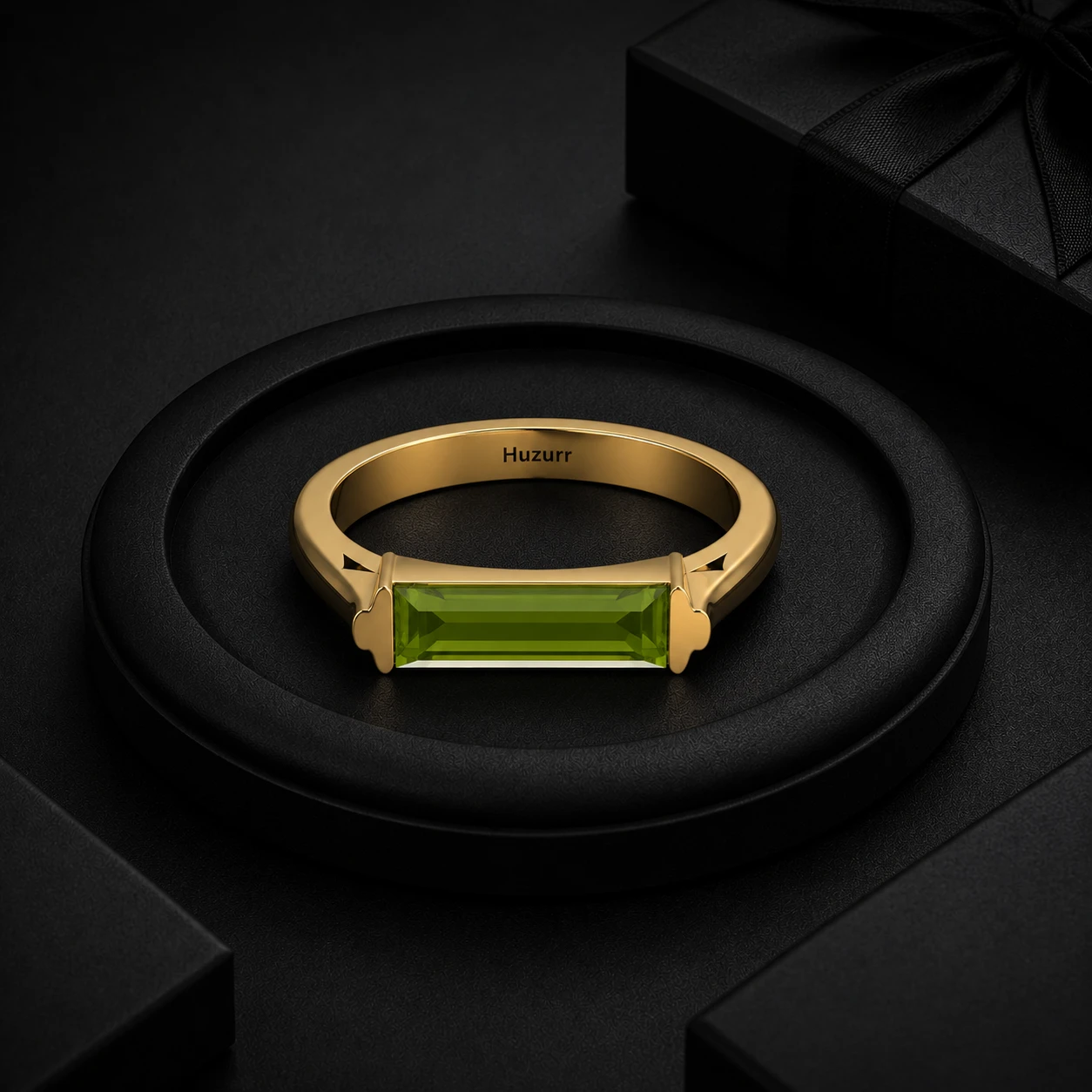 Baguette-cut green peridot flush-set horizontally along a thick gold-plated bar style ring band