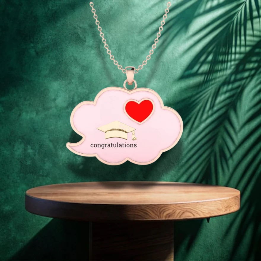Pink enamel cloud rose gold plated pendant design with a graduation cap, red heart, and congratulations engraving