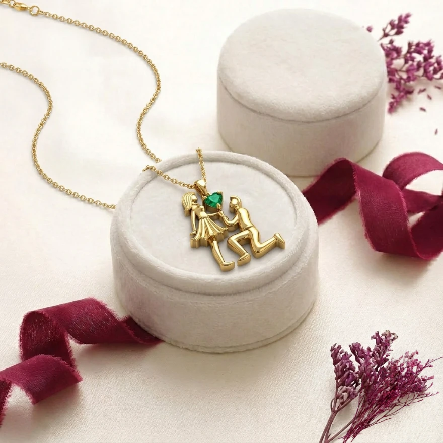 Rose gold-plated couple proposal pendant featuring a heart shaped green emerald gemstone