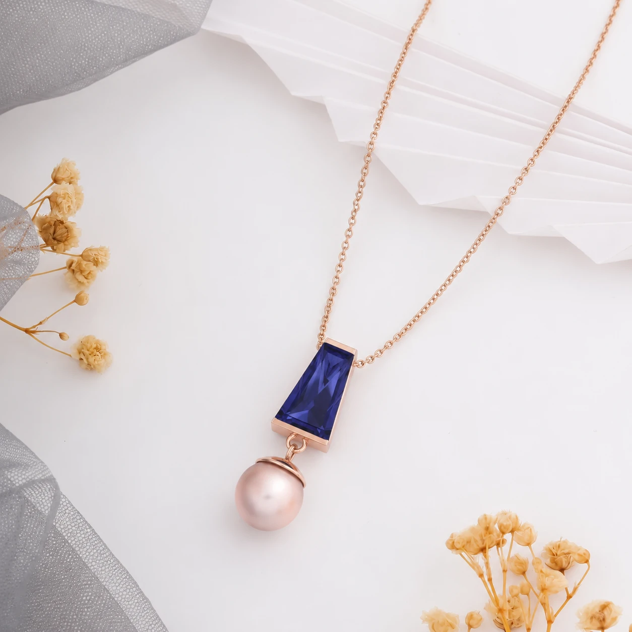 trapezoid tanzanite necklace with Rose gold plating and dangling pearl