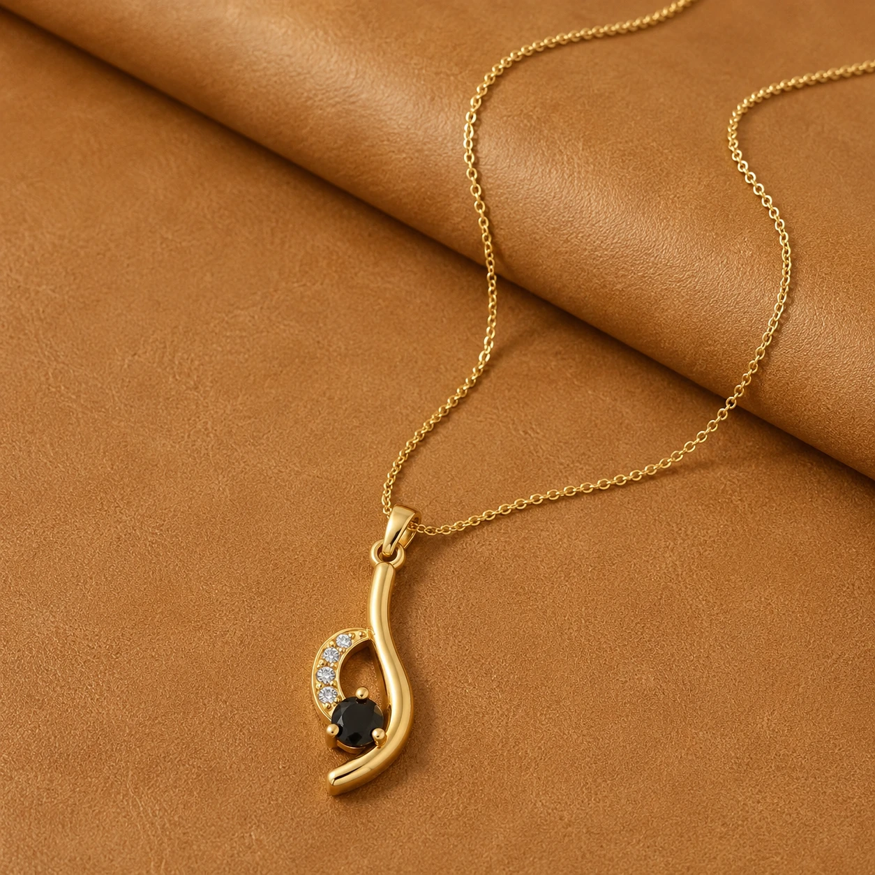 Round black diamond solitaire pendant necklace in a curved yellow gold plated wave setting with accent diamonds.