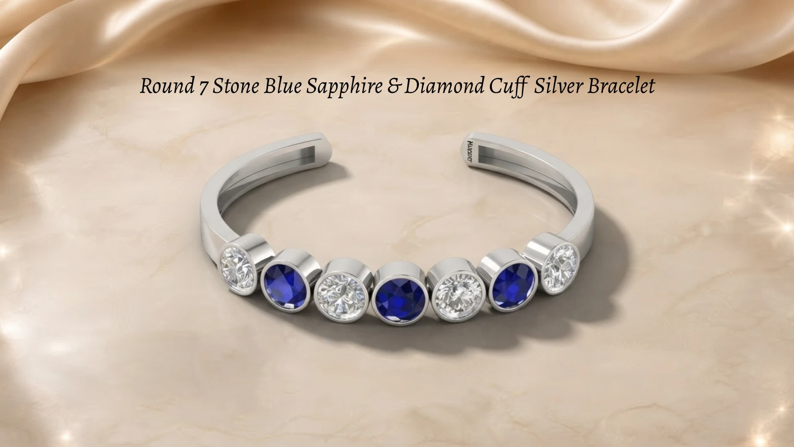 Blue sapphires and round diamonds set alternately on a classic silver cuff bracelet.