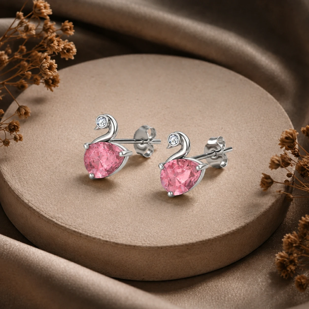 Sterling silver duck style stud earrings featuring pear shaped pink morganite gemstones and accent diamonds
