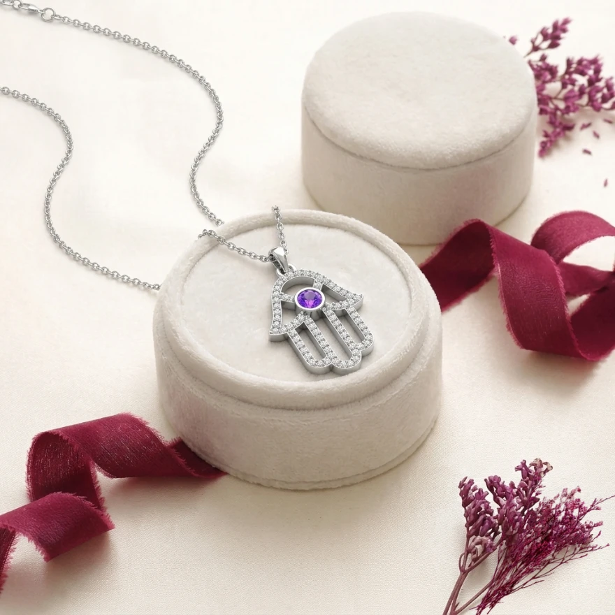 Sterling silver Hamsa hand necklace featuring a purple amethyst center and a diamond outline