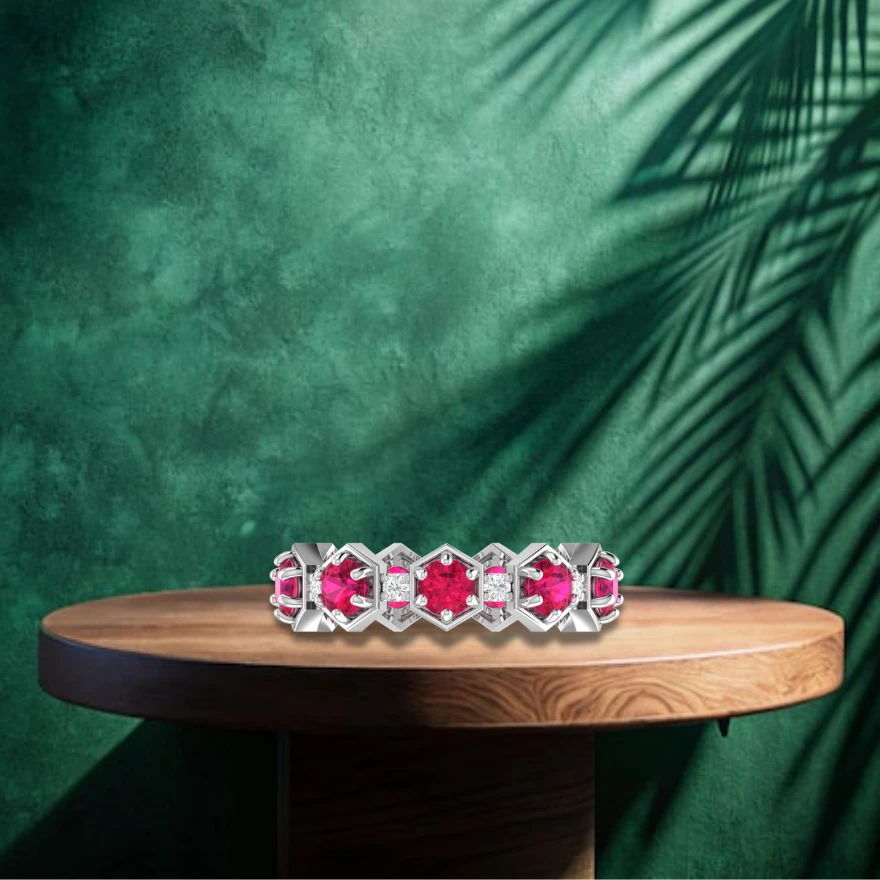 Round pink rubies inside hexagon shapes alternate with small diamonds on a silver ring