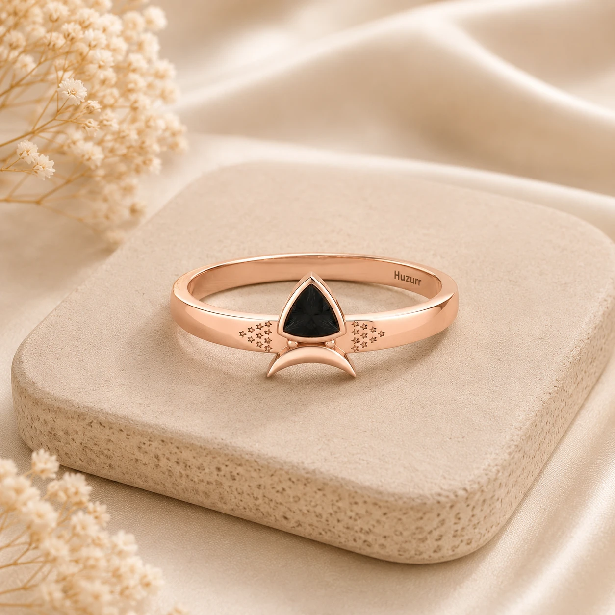 Trillion cut black diamond ring in a rose gold plated bezel setting with a curved crescent accent and star engravings