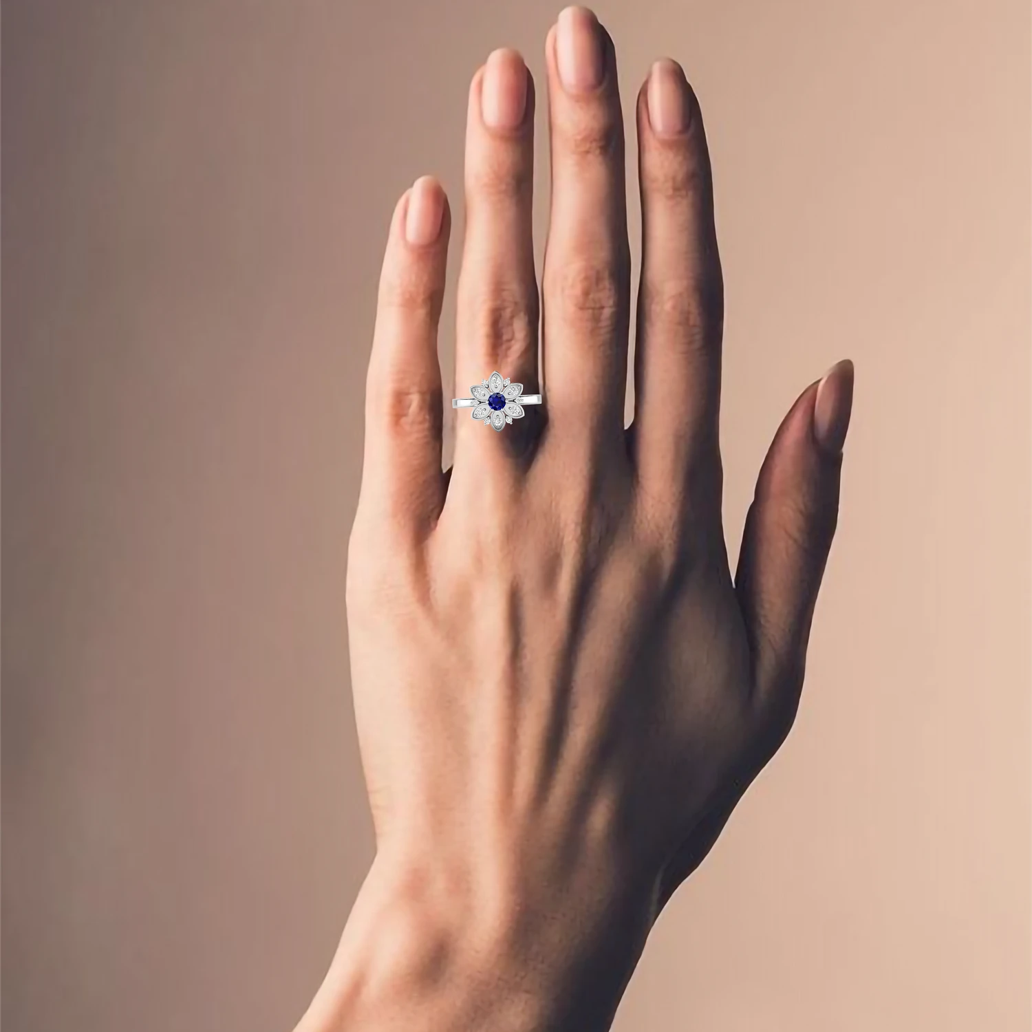 blue sapphire silver ring worn on hand